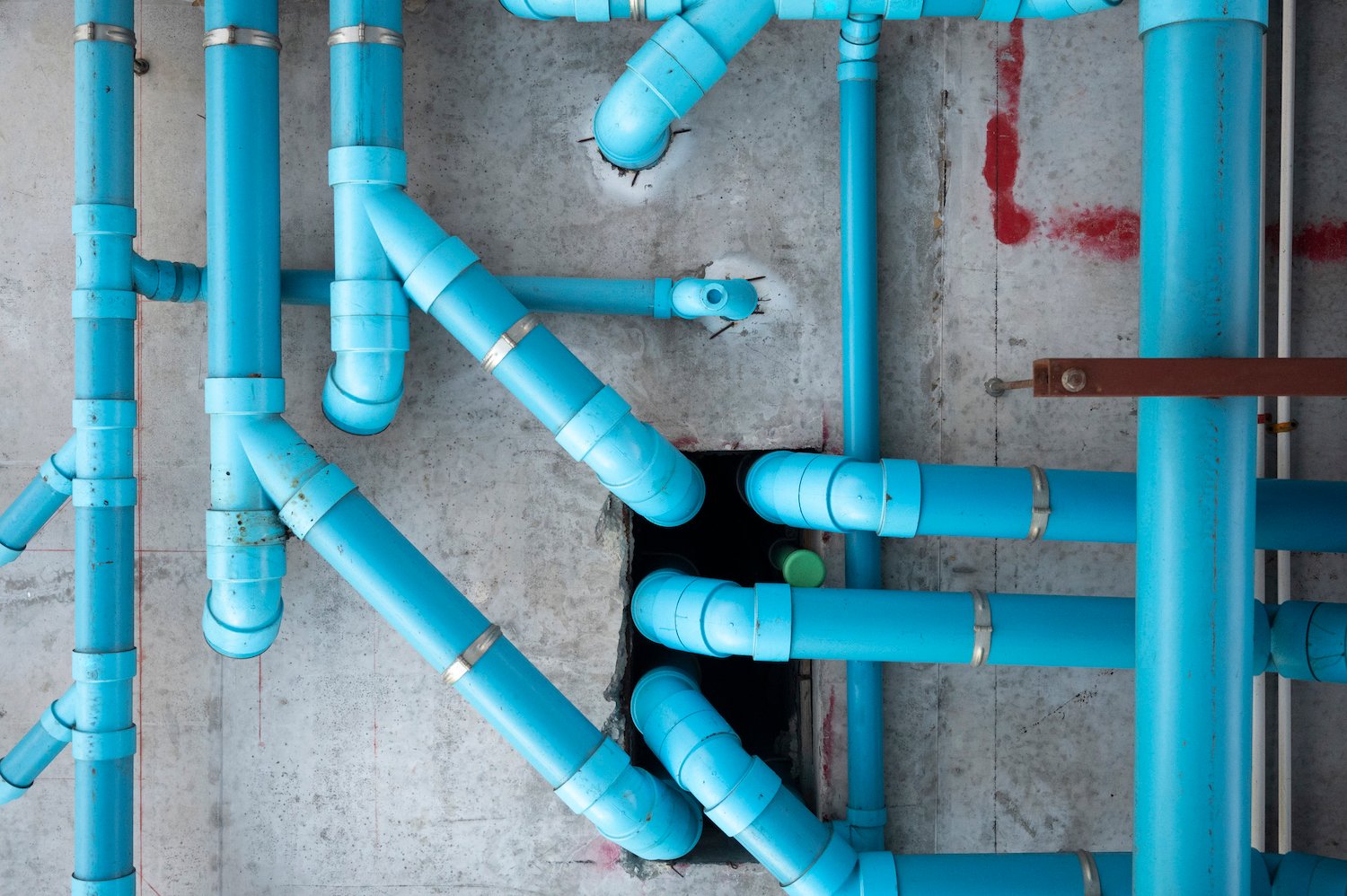 Low angle view of blue pipes attached to ceiling. How to build an sales development representative strategy that will fill your B2B pipeline